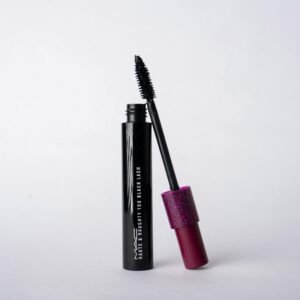 Black mascara product on white background with pink glitter cap.