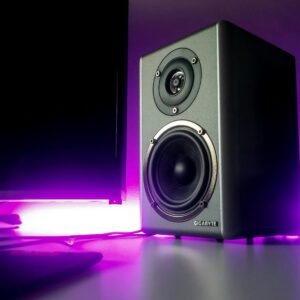 High-quality speaker setup with vibrant purple lighting in a modern studio setting.